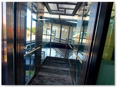 Glass passenger stretcher lift