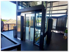 Glass passenger stretcher lift