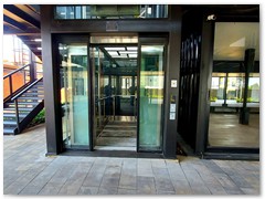 Glass passenger stretcher lift