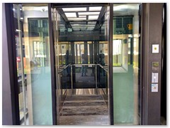 Glass passenger stretcher lift
